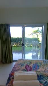 a bedroom with a bed and a large window at Sunview in Savusavu +10 photos