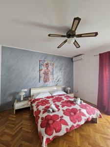 a bedroom with a bed and a ceiling fan at Apartments Perina Tisno in Tisno