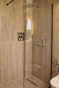 a shower with a glass door in a bathroom at Hotel "Villa Niche" By Bratheim in Tirana +38 photos