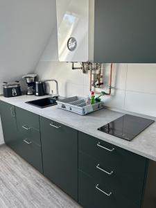 a kitchen with a sink and a counter top at Ferienwohnung am Uniklinik in Lübeck