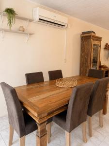 a dining room table with chairs around it at Farol House in Pântano Grande +1 photo
