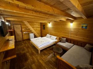 a room with a bed in a wooden cabin at Lagano Mountain Retreat - Via Ferrata & Restaurant in Gusinje +54 photos