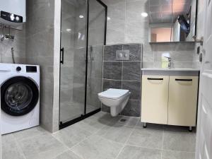 a bathroom with a washing machine and a washer at Pakiş Bungalov in Dosemealti +35 photos