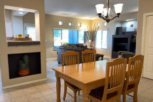 a dining room and living room with a table and chairs at Vistoso Resort Casita #163 in Oro Valley