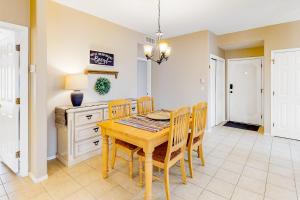 a dining room with a wooden table and chairs at Vistoso Resort Casita #163 in Oro Valley