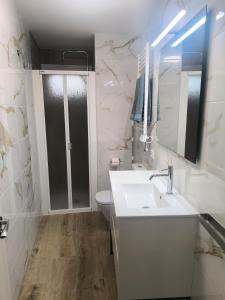 a bathroom with a sink and a toilet and a mirror at VuT El Mirlo in Frías