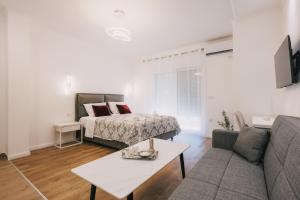 a living room with a bed and a couch at Dëshira Apartments in Ulcinj