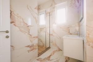 a bathroom with a shower and a sink and a mirror at Dëshira Apartments in Ulcinj +49 photos