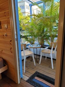 a patio with chairs and a table and a table at Serenity Cabin in Dalia in Dāliyat el Karmil