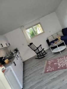 a living room with a couch and a table at Serenity Cabin in Dalia in Dāliyat el Karmil +8 photos