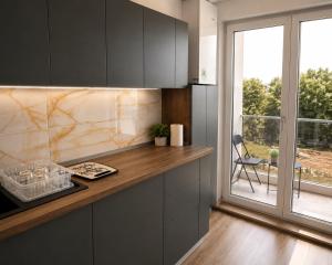 a kitchen with a counter and a large window at Rion Apartments in Saturn