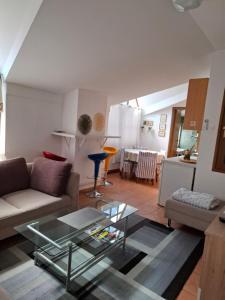 a living room with a couch and a glass table at RETRO Apartments in Bjelovar