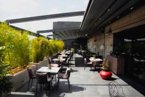 a row of tables and chairs on a patio at Palace Hotel & SPA in Mitrovica