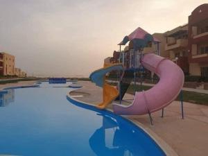 a water slide in a swimming pool at لاسيرينا عيون موسى LaSerinaللعائلات in Ras Sedr