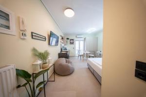 a living room with a bed and a dining room at Modern Studios for Two in Mytilene