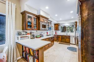 a kitchen with wooden cabinets and a white counter top at Meadow Creek House in Idyllwild