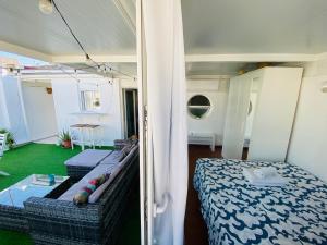 a room with a bed and a couch and a table at Ático Cádiz Suite in Cádiz