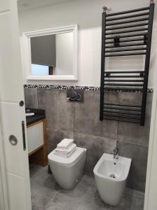 a bathroom with a toilet and a sink and a mirror at La casa di Simona in Pistoia