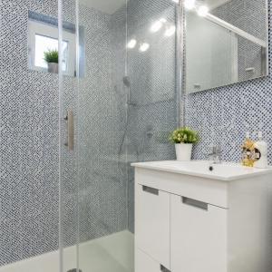a bathroom with a glass shower and a sink at A Casa do Jamor in Cruz Quebrada