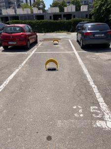 a yellow object in a parking lot with cars at Rion Apartments in Saturn