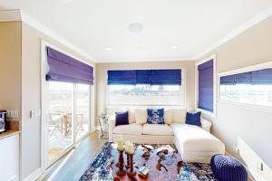 a living room with a couch and a table at Gull Cottage in Seal Beach