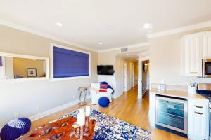 a living room with a couch and a table at Gull Cottage in Seal Beach +33 photos