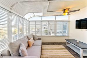 a living room with a couch and a table at Seashore Dreams B - Upper Unit in Newport Beach