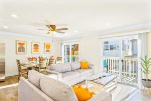 a living room with a couch and a table at Seashore Dreams B - Upper Unit in Newport Beach