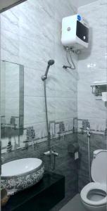 a bathroom with a shower and a sink and a toilet at Thanh Dat 2 Hotel in Vinh