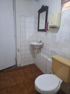 a bathroom with a toilet and a sink at Suíte Centro Histórico in São Luís