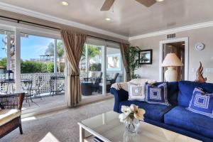 a living room with a blue couch and a table at San Clemente - Monterey Fourplex in San Clemente +28 photos