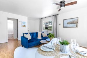 a living room with a blue couch and a table at San Clemente Sunset in San Clemente
