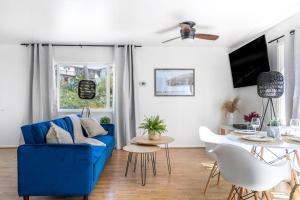 a living room with a blue couch and a table at San Clemente Sunset in San Clemente