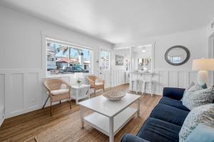 a living room with a blue couch and a table at Newport Coastal Charm in Newport Beach