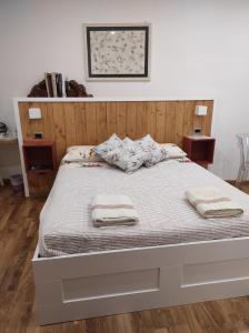 a bedroom with a bed with two towels on it at La casa di Simona in Pistoia