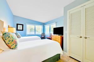 a bedroom with a white bed and blue walls at Tommy Bahama Beach Rd II in Dana Point +12 photos