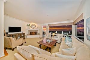 a living room with a couch and a fireplace at San Clemente Ocean Luxury Bluff Top in San Clemente