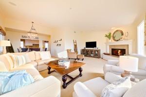 a living room with white furniture and a fireplace at San Clemente Ocean Luxury Bluff Top in San Clemente