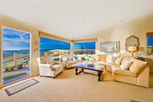 a living room with white furniture and a large window at San Clemente Ocean Luxury Bluff Top in San Clemente