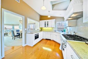 a kitchen with white cabinets and a stove top oven at San Clemente Ocean Luxury Bluff Top in San Clemente +20 photos
