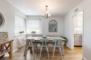 a dining room with a white table and chairs at Evening Oasis in Orange