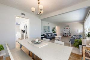 a living room with a table and a dining room at Evening Oasis in Orange