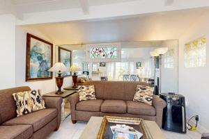 a living room with two couches and a table at Relaxation Station in Corona del Mar