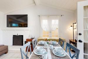 a dining room with a table and chairs and a fireplace at Relaxation Station in Corona del Mar +18 photos