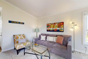 a living room with a couch and a glass table at Monarch Vista in Dana Point