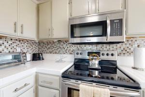 a kitchen with a stove and a microwave at Monarch Vista in Dana Point