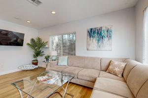 a living room with a couch and a glass table at Sunshine Fun Time in Newport Beach