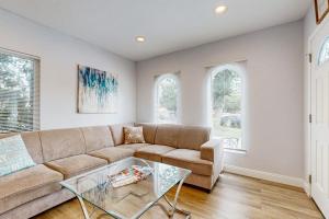a living room with a couch and a glass table at Sunshine Fun Time in Newport Beach