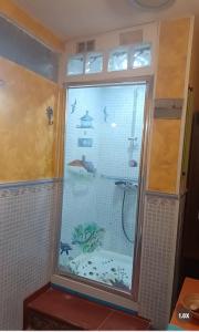 a shower with a fish tank in a bathroom at Seaview Faro Arinaga in Arinaga +46 photos