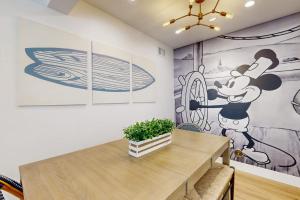 a dining room with a mickey mouse mural on the wall at Mickey's Hideaway in Anaheim